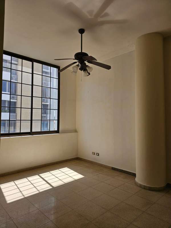 Spacious living room with natural light, ceiling fans and balcony PH Ariadne building