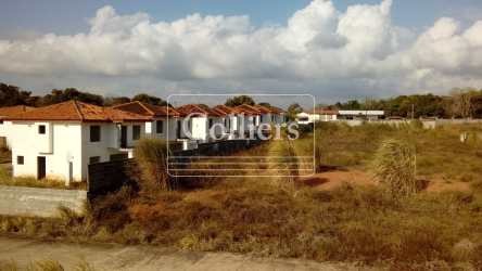Partially built houses with red tile roofs and open land in Costa Verde La Chorrera Panama