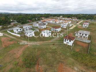 Aerial shot unfinished housing estate with detached houses, empty lots Costa Verde La Chorrera Panama