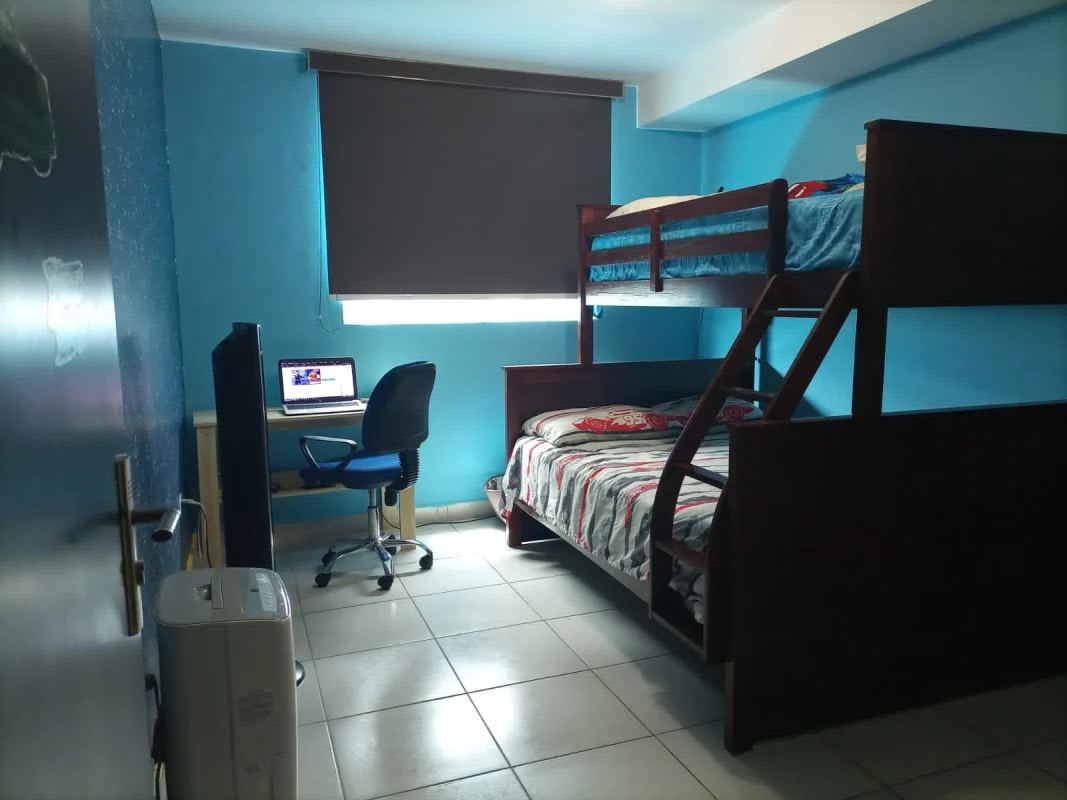 Primary bedroom with neutral decor, split AC, tile floors, queen bed in PH Premium San Francisco