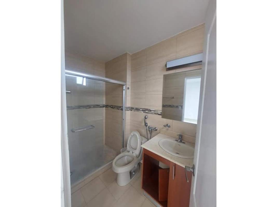 Bedroom with large window, closet and tile floor in Panama apartment for sale