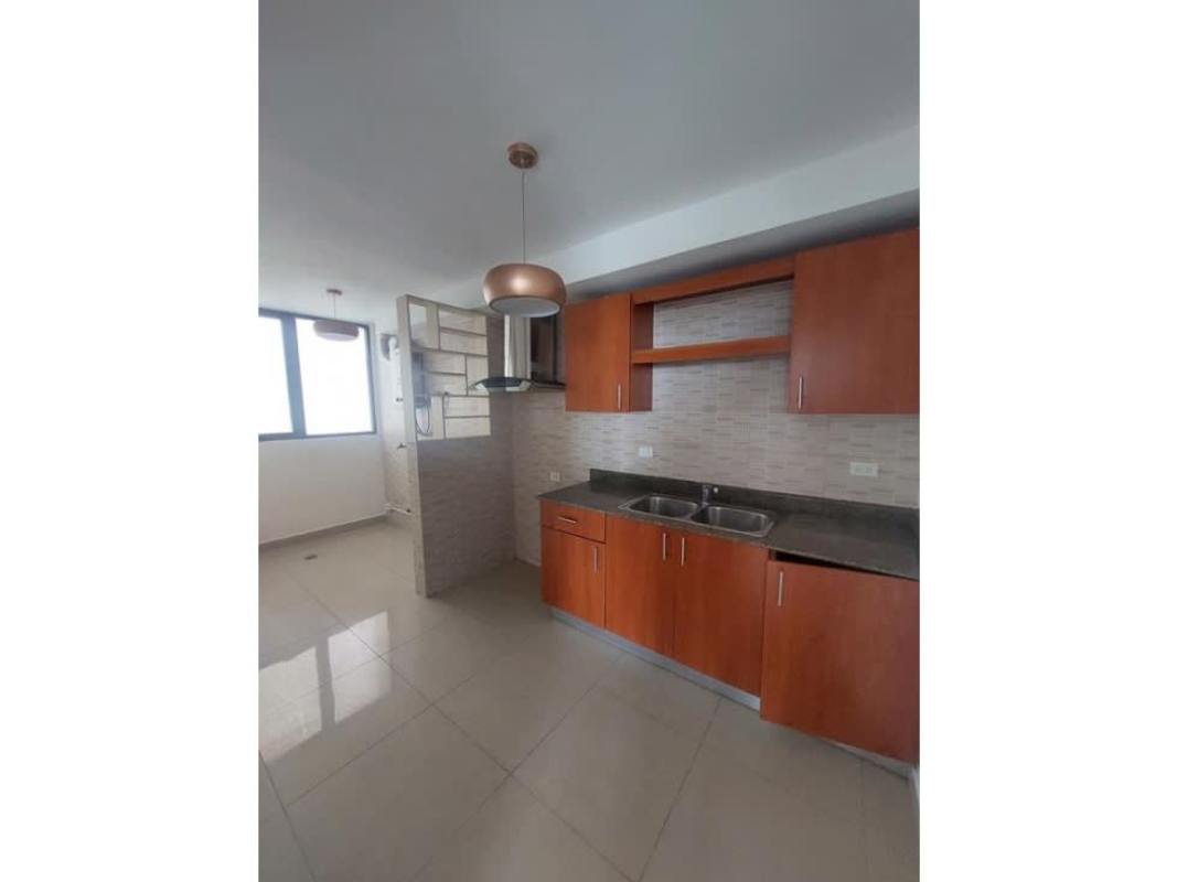 Bright kitchen with granite counters, wooden cabinets, and double sink San Francisco Panama