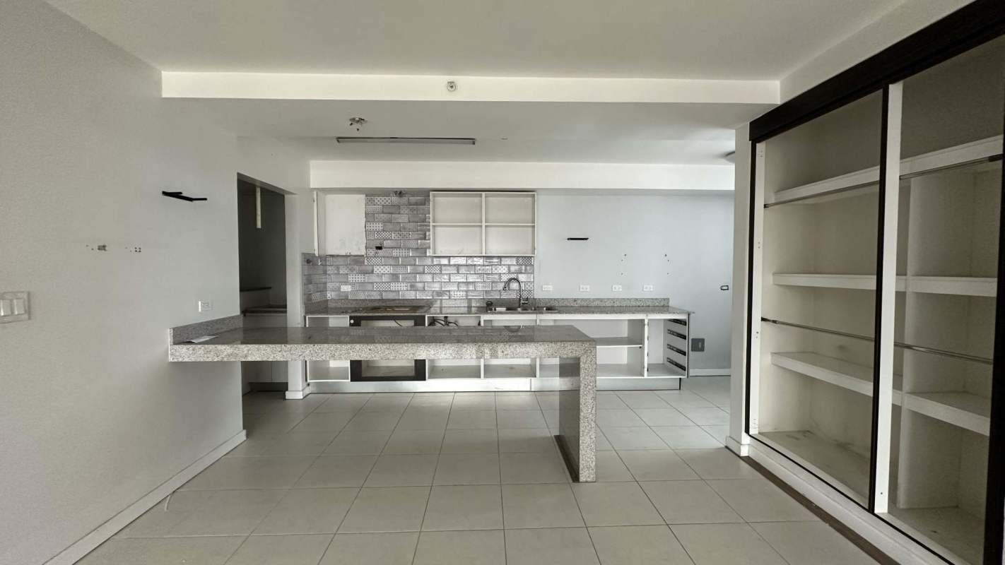 Spacious open kitchen granite island metallic backsplash PH Miro apartment Panama