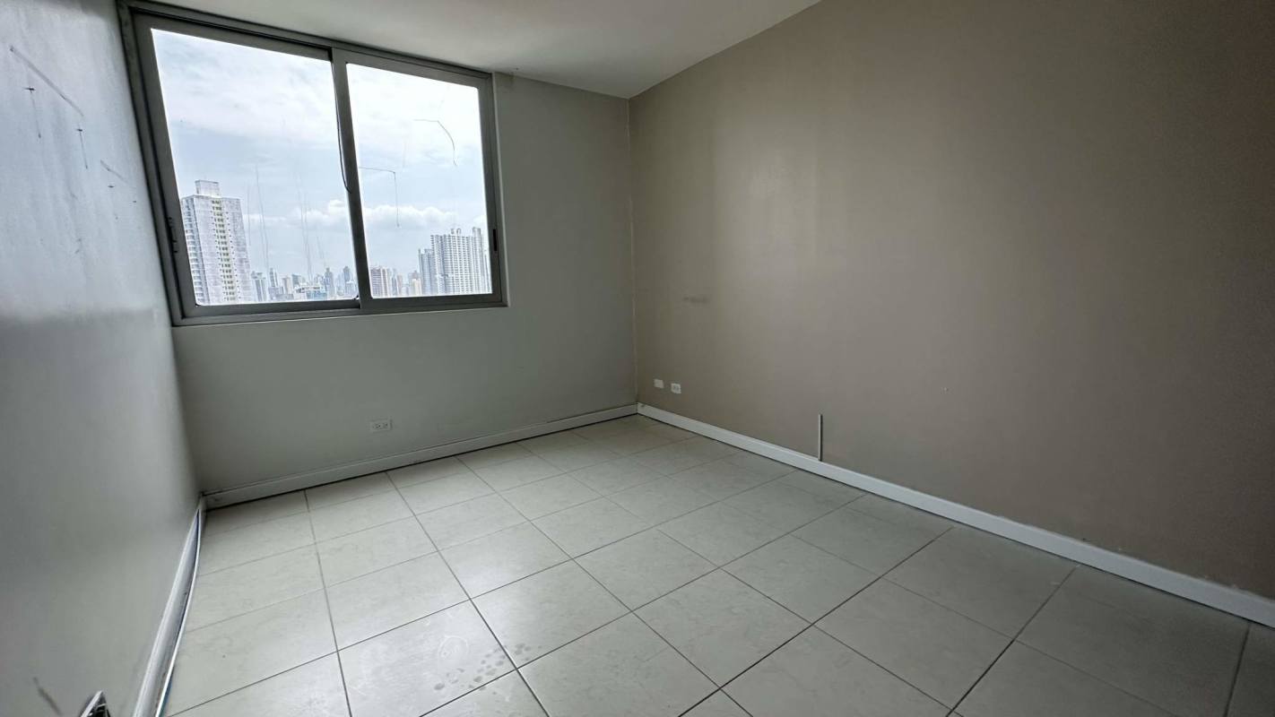 Bedroom with city skyline through window at PH Miro Panama for sale