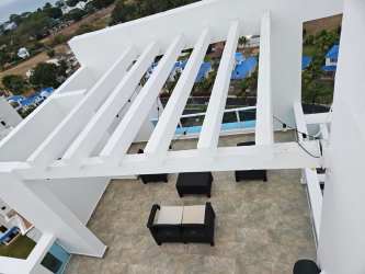 Rooftop terrace with pergola and outdoor seating overlooking ocean PH Founders Playa Blanca Panama