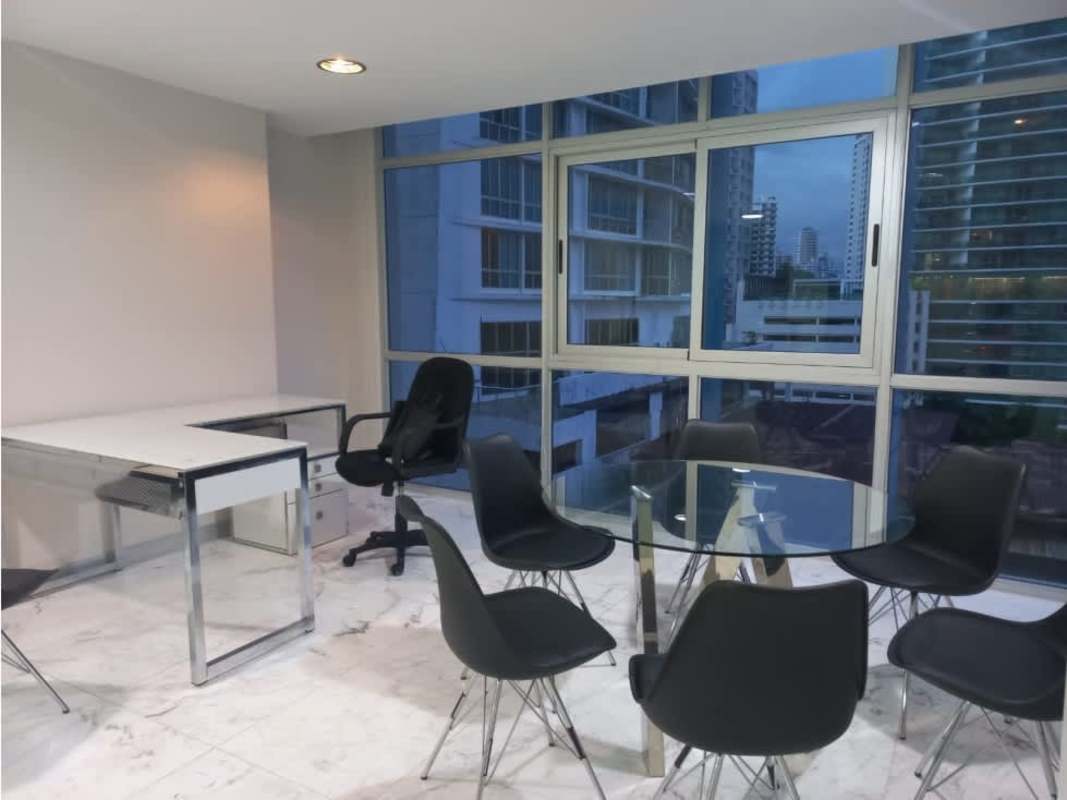 Minimalist home office setup with large window and L-shaped desk Bella Vista PH Colores