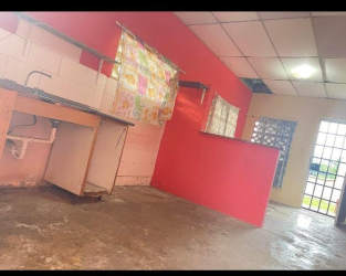 Simple kitchen with red accent wall and tiled backsplash Guadalupe La Chorrera Panama Oeste