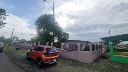 Street view of property with pink perimeter wall in La Chorrera Panama Oeste