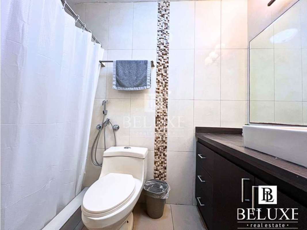Bathroom with bathtub, beige tiles, mirror above sink in Villa Aurora Betania furnished rental Panama City