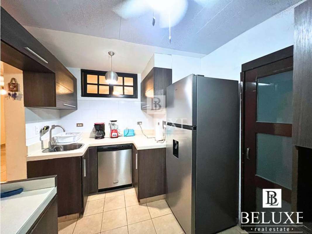 Contemporary kitchen with dark and white cabinetry, tile floors, appliances PH Villa Aurora Bethania