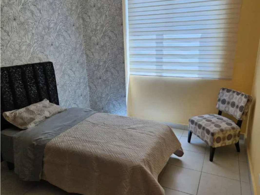 Single bedroom with accent wallpaper, window with blinds in PH Miro Panama