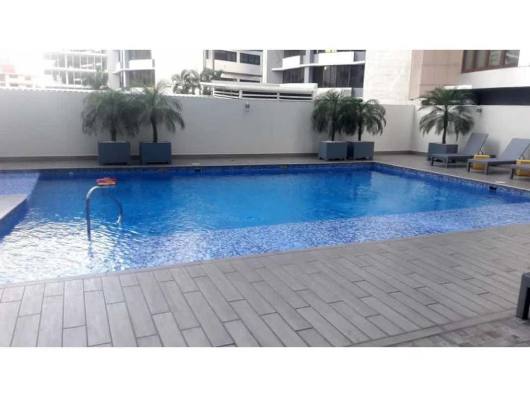 Swimming pool with lounge chairs and palm trees PH Miro Panama City