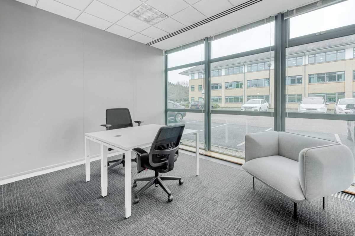 Modern minimalist private office with desks chairs and large window in F&F Tower Panama