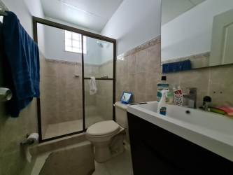 Spacious covered terrace with rustic furniture, tiled floor, plants Colinas del Sol Panama