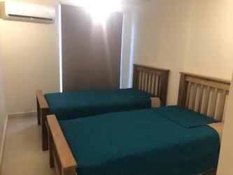 Bedroom with twin beds, split AC, window overlooking gardens PH Altamarina Playa Dorada Panama