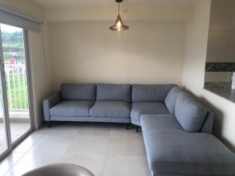 Modern furnished living room with balcony access and oceanfront view in PH Altamarina Playa Dorada Panama