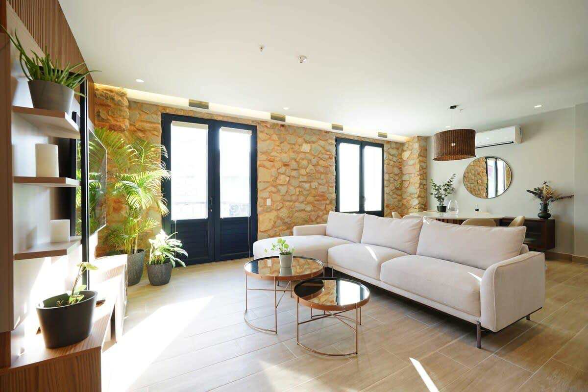 Living area with accent wall, city views, modern furnishings in Casco Viejo Panama