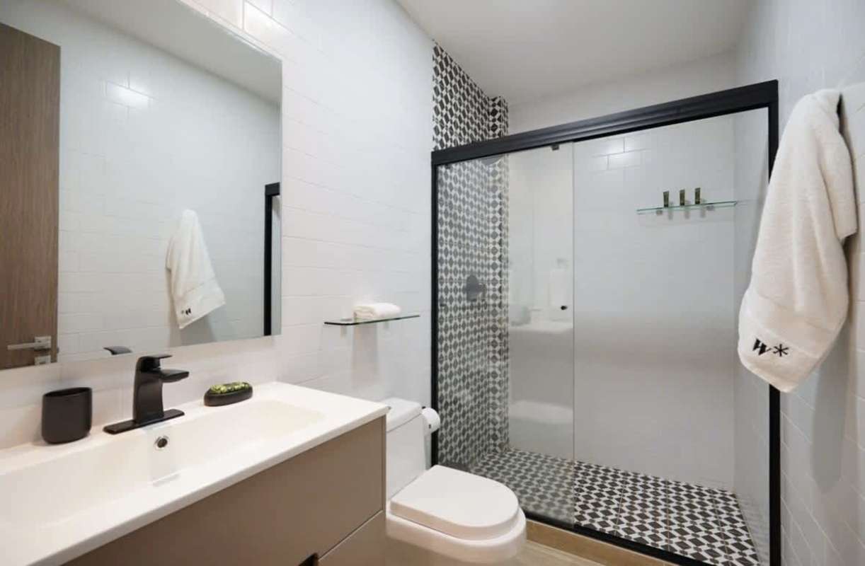 Open kitchen with stylish island, appliances, and pendant lighting in La Cuadra Casco Viejo