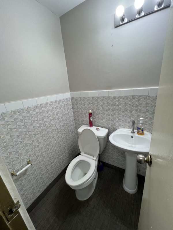 Compact bathroom with pedestal sink and toilet ground floor retail Marbella Panama