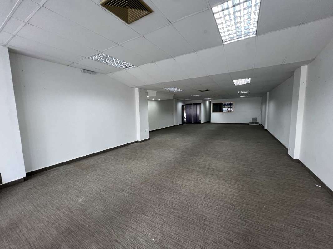 Large glass retail frontage with street and parking view Plaza Marbella Panama