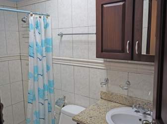 Kitchen with granite countertops, dark wood cabinets, appliances in La Paz de Chame guest house