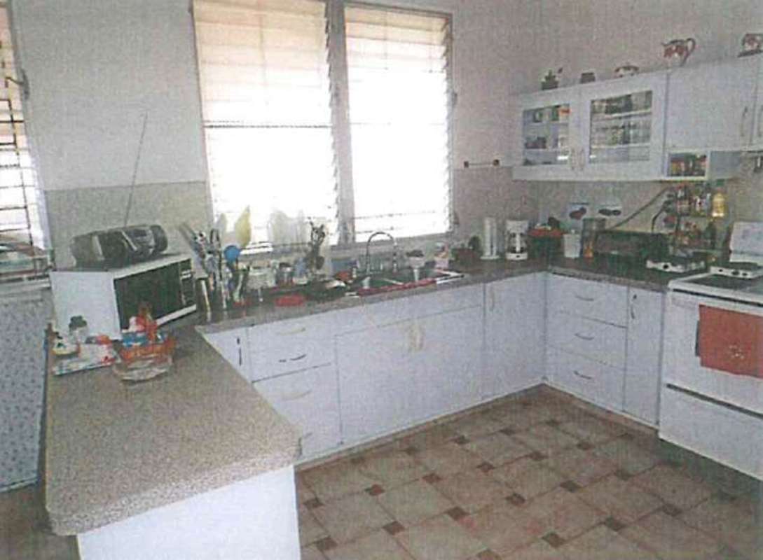 Street view of single story mid-century modern house with garden Villa Lilla Panama City