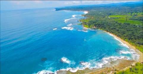 Aerial coastline with white sand beach lush forest and clear blue waters Palenque Panama