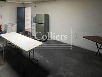 Break room with tables, refrigerator and water cooler France Field warehouse Colón