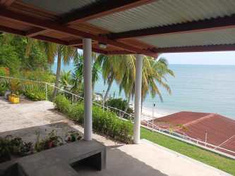 Spacious living area with tiled floors and glass doors to ocean terrace SolyMar Estate Panama