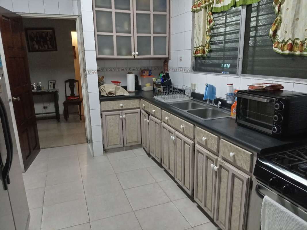 Kitchen with frosted cabinets microwave sink tile Betania Panama home