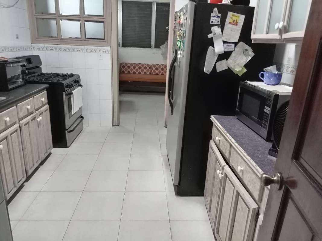 Classic kitchen with stainless appliances tile flooring wood cabinets Betania Panama City home