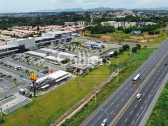 Front view of Plaza OnDGo with multiple storefronts, glass facades, ample parking in La Chorrera Panama