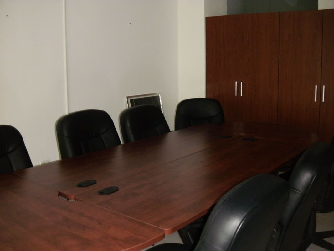 Private conference room with wood table and leather chairs in Ocean Business Plaza