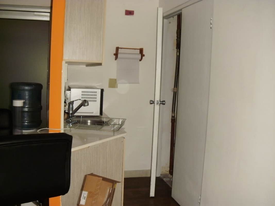 Small kitchenette with microwave, sink, and storage in Ocean Business Plaza Marbella