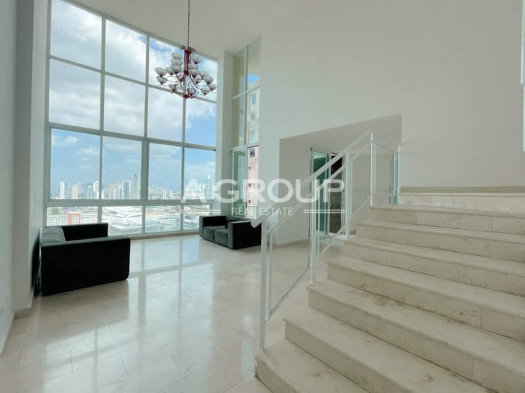 Panoramic city skyline from double height windows inside Junior Penthouse Costa Pacifica Panama