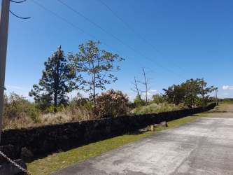 Stone boundary wall with paved driveway and open natural land acreage in Boquete Panama