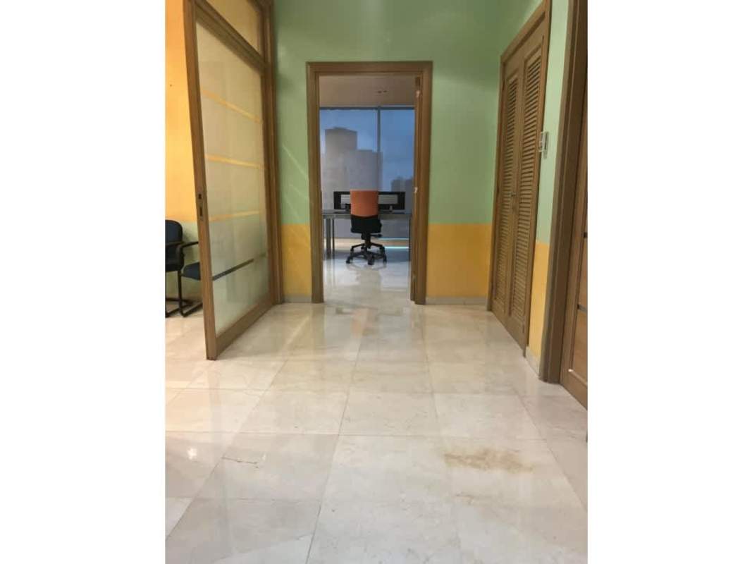Entrance and hallway with glass sliding door leading to corporate workspace PH Torre Global Panama