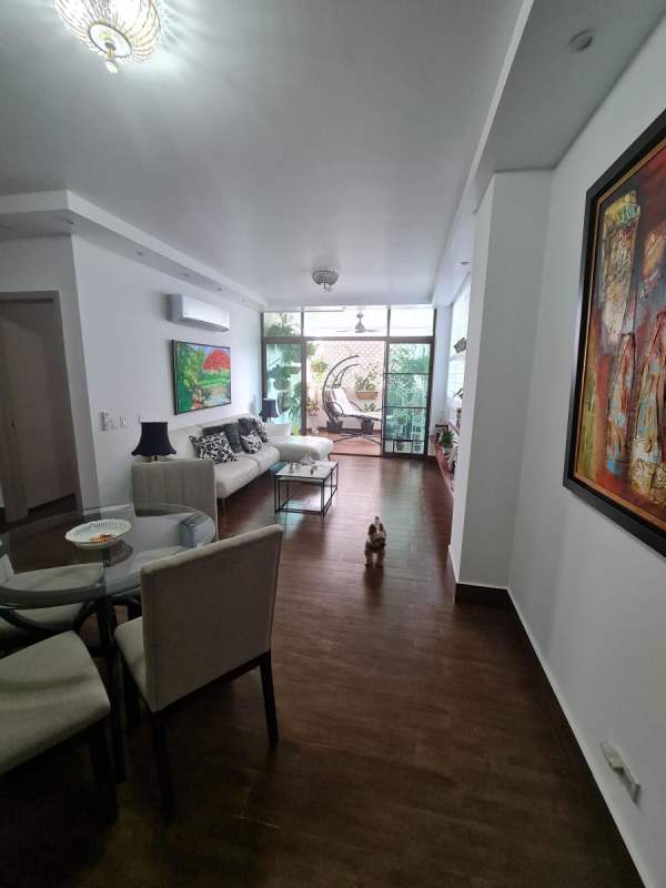 Modern living and dining area opening onto balcony in PH Costa Sur Gardens Panama
