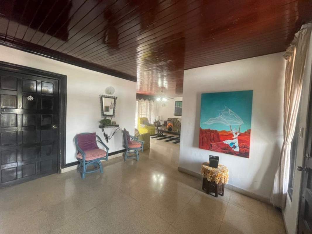 Multi-use space with ceiling fan, windows, and furniture set up as bedroom or office Los Angeles Panama