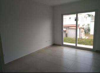 Spacious empty living room with sliding glass doors The Village Beach Residence rental Panama