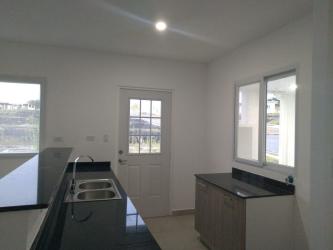 Contemporary kitchen with granite counters in The Village Beach Residence San Carlos Panama