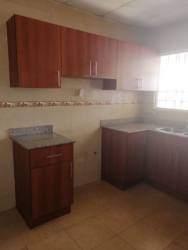 Bathroom with beige tiles, shower with curtain in Mirador del Bosque house Guararé Panama