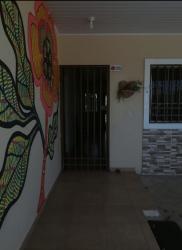 Covered porch entrance with decorative wall art at house in Guararé Los Santos Panama