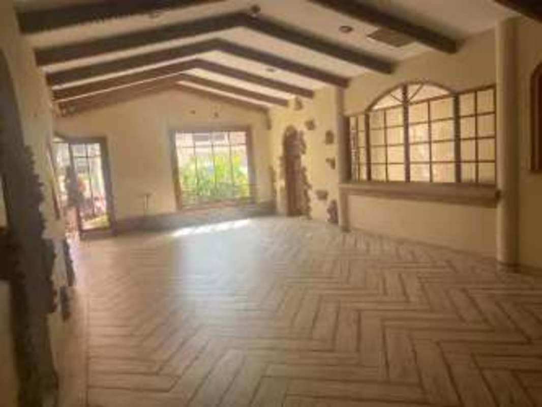 Rustic foyer with staircase and wood beams commercial property Bella Vista Panama