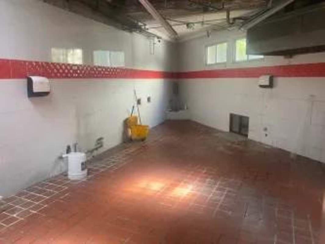 Commercial kitchen with white tile walls and open prep areas in Bella Vista Panama City