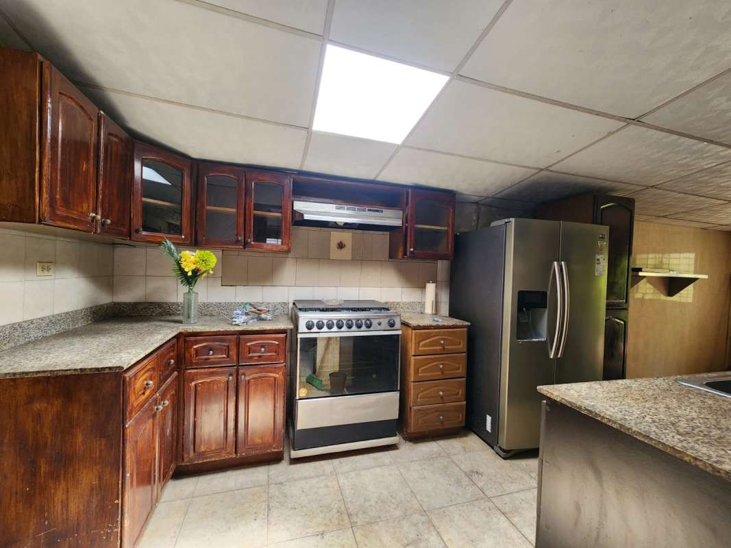 Covered patio with iron railings decorative plants hanging art suburban home Panama City