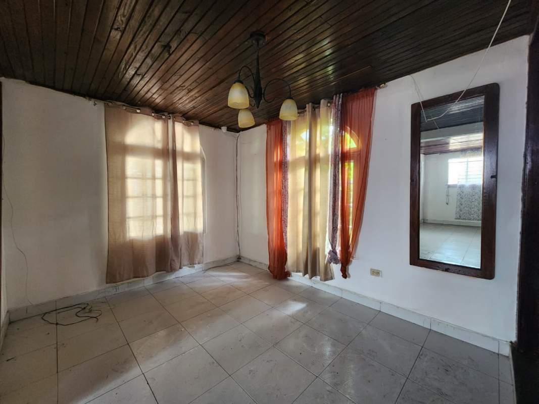 Spacious living room with wood panel ceiling tile floor large windows Pueblo Nuevo