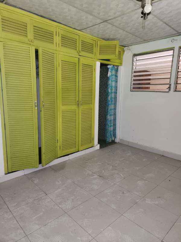 Bedroom with green closet doors tiled floor window natural light Villa Rica Pueblo Nuevo