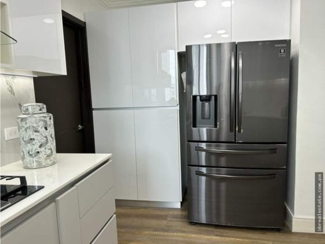 Luxury kitchen with built-in appliances, light cabinetry and marble accents PH Costa del Este Country Club Panama