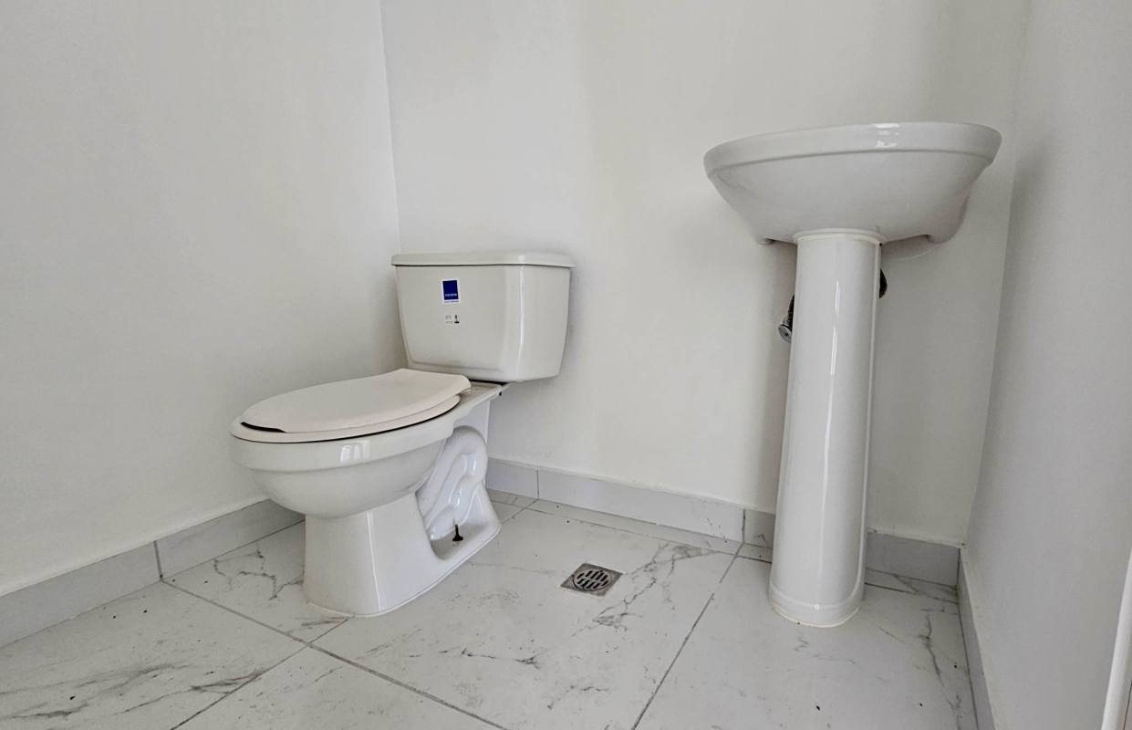 Corner commercial office interior in Sortis Tower with large windows and marble floor tiles Panama City